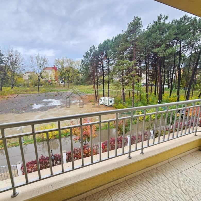 Balcony overlooking pool and lush greenery in Sunny Beach.