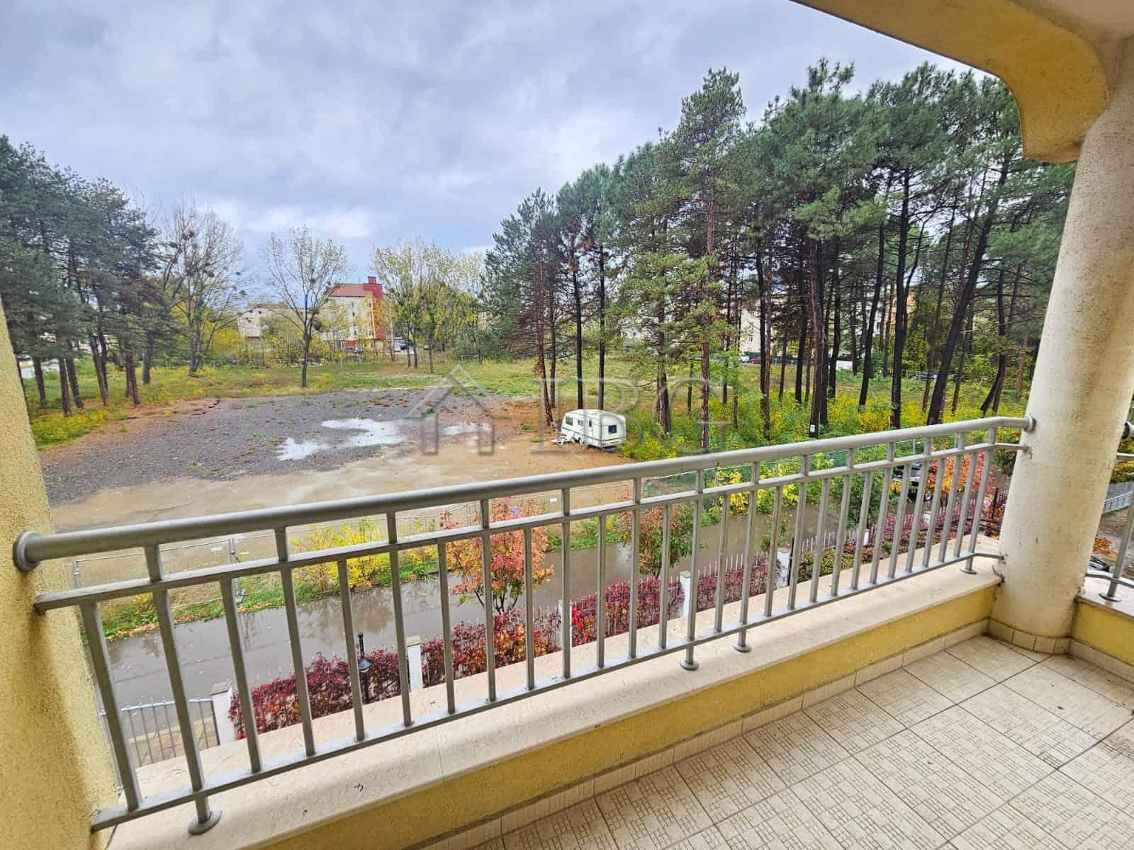 Balcony overlooking pool and lush greenery in Sunny Beach.