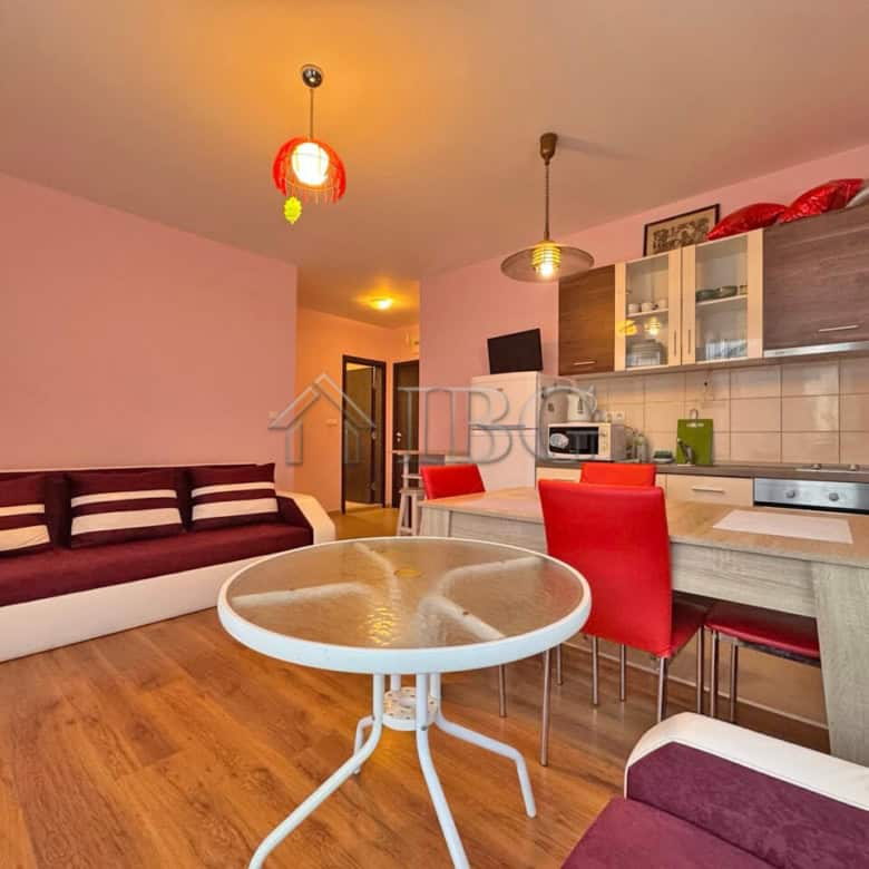 Apartment with pool view in Sunny Beach, Bulgaria, featuring a modern living area and open kitchen.