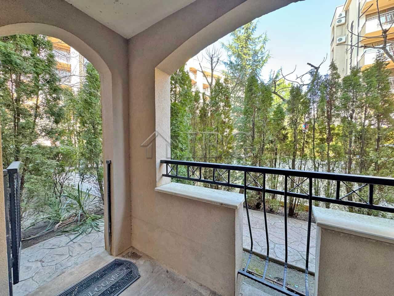 Balcony overlooking trees at Cascadas Family Resort, Sunny Beach, Bulgaria, offering a peaceful outd.