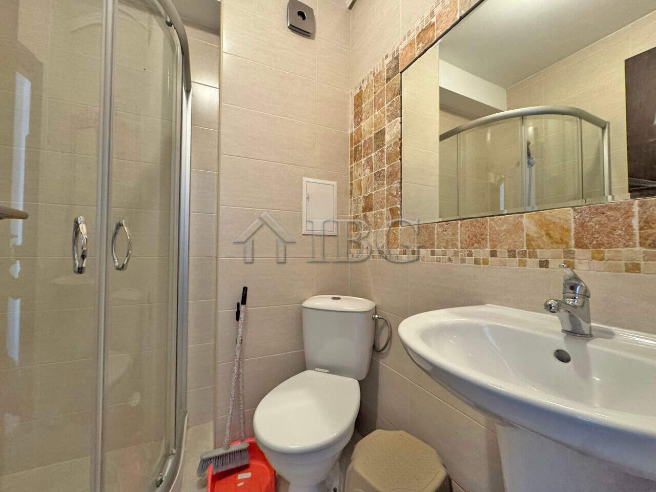 Modern bathroom with shower, toilet, and sink in Sunny Beach apartment.