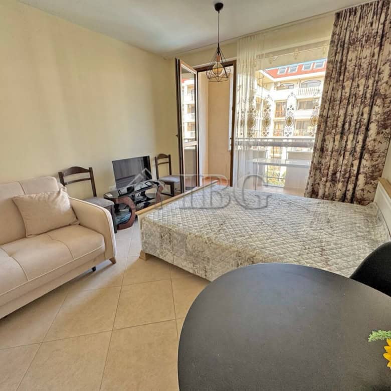 Bright studio apartment with a comfortable bed and living area in Sunny Beach.