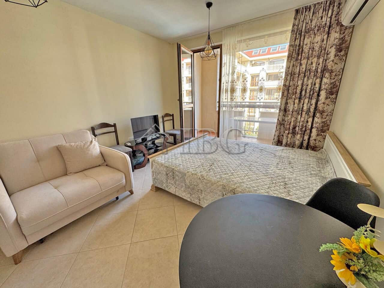 Bright studio apartment with a comfortable bed and living area in Sunny Beach.