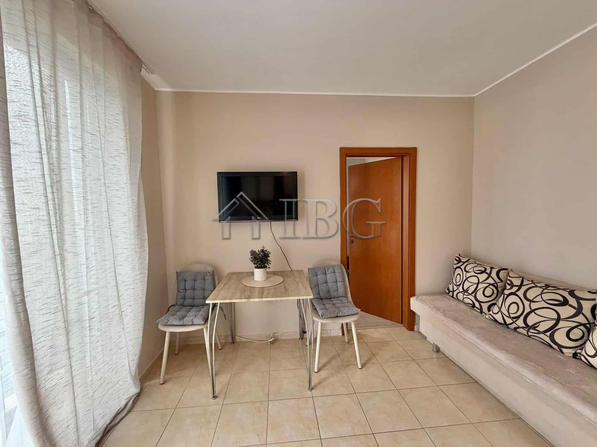 Bright 1-bedroom apartment with living area and seating in Sunny Beach, Bulgaria.