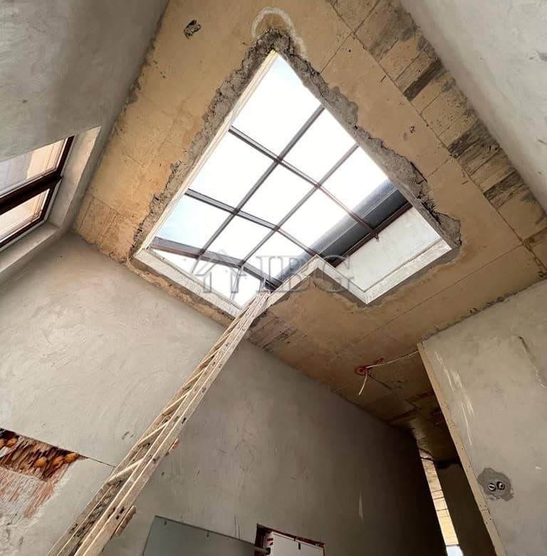 Bright interior with large skylight providing natural light.