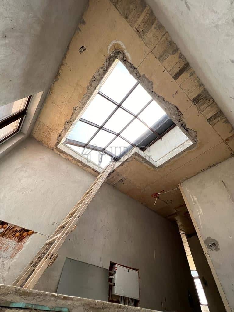 Bright interior with large skylight providing natural light.