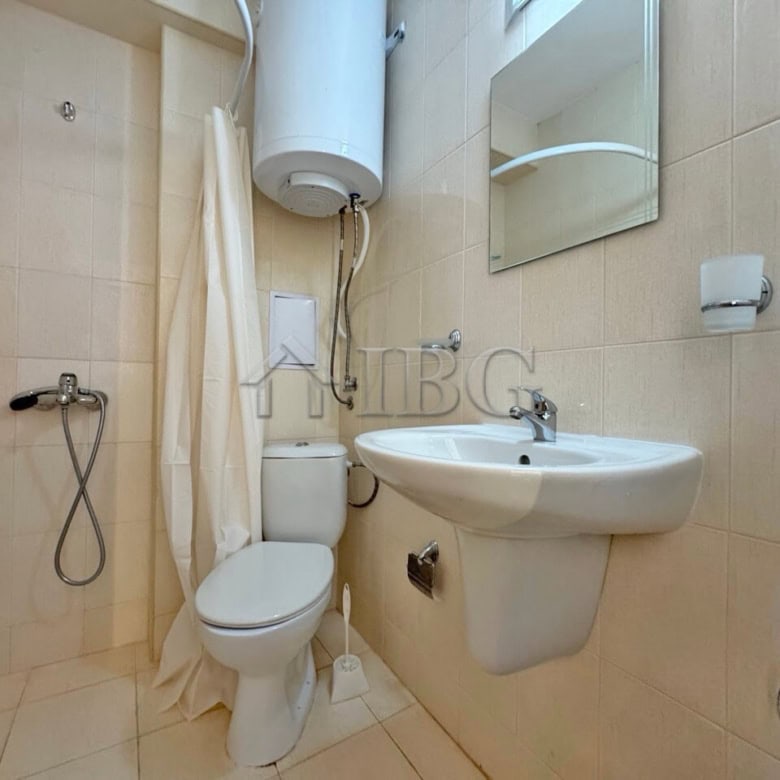 Compact bathroom with shower, toilet, and sink in Diamond Bay studio apartment, Sunny Beach.