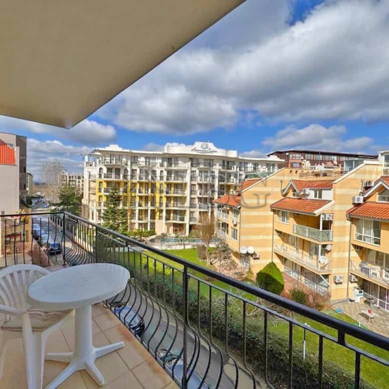 Balcony overlooking Sunny Beach with modern buildings and blue sky.