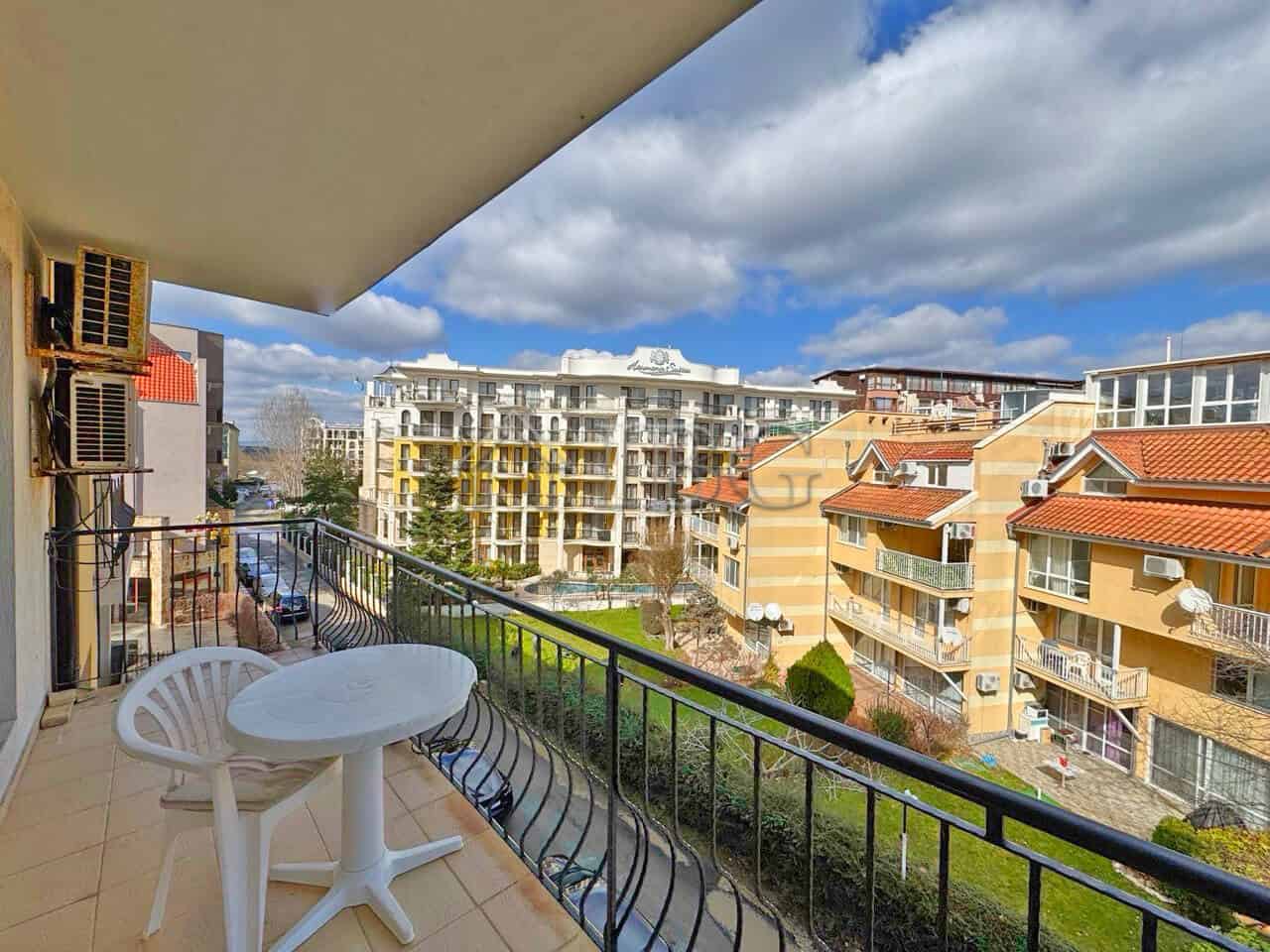 Balcony overlooking Sunny Beach with modern buildings and blue sky.