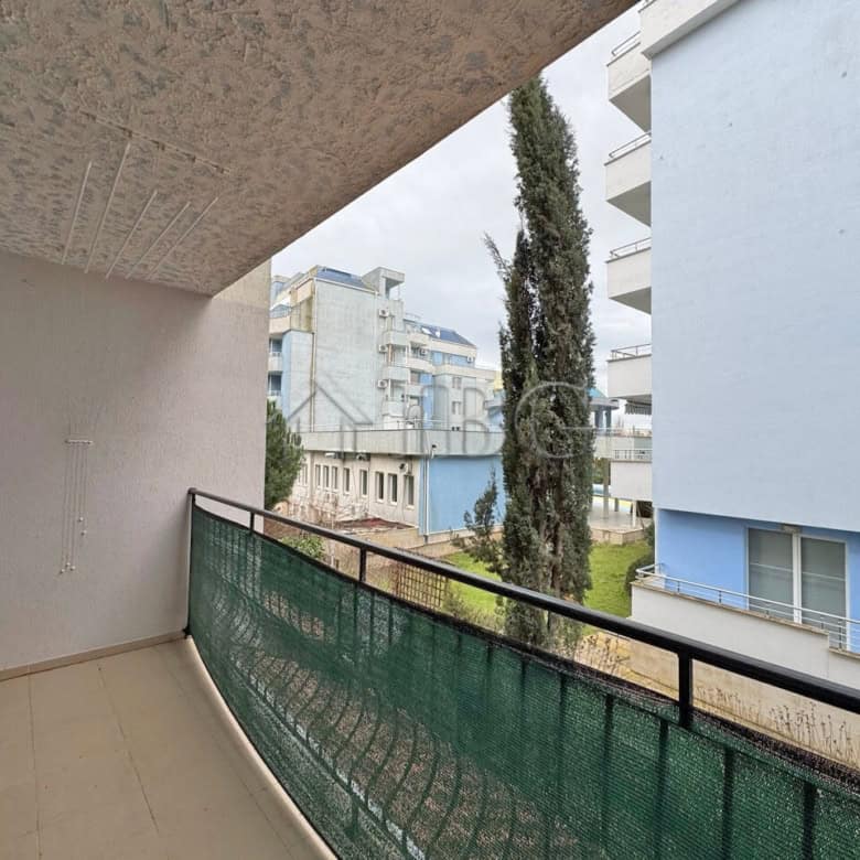 Balcony view of a studio apartment in Diamond Bay, Sunny Beach, with modern buildings and greenery.