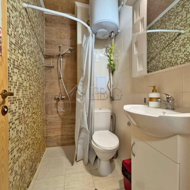 Compact studio bathroom with shower and modern fixtures in Diamond Bay, Sunny Beach.