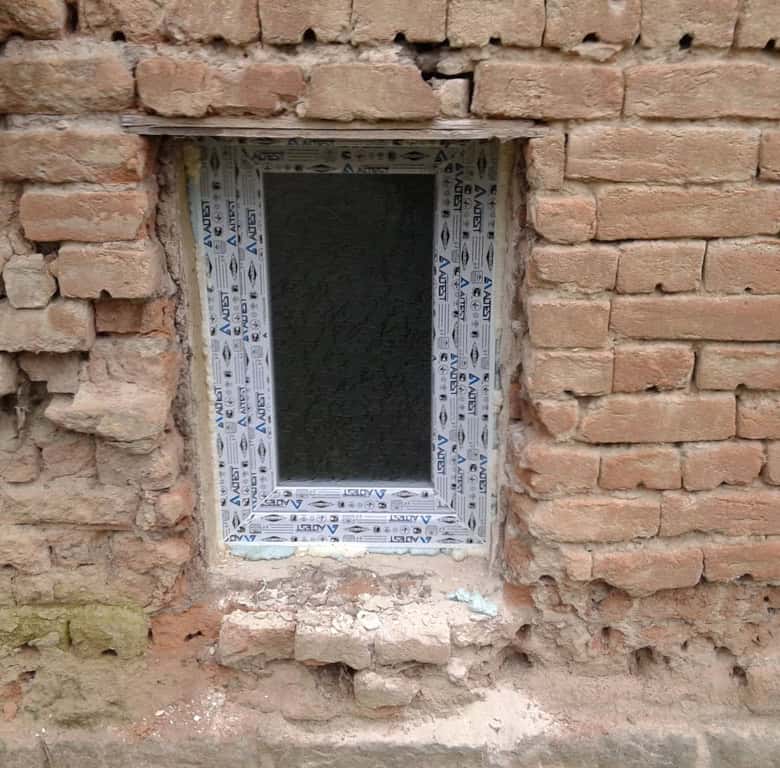 Brick wall with window opening for renovation project.