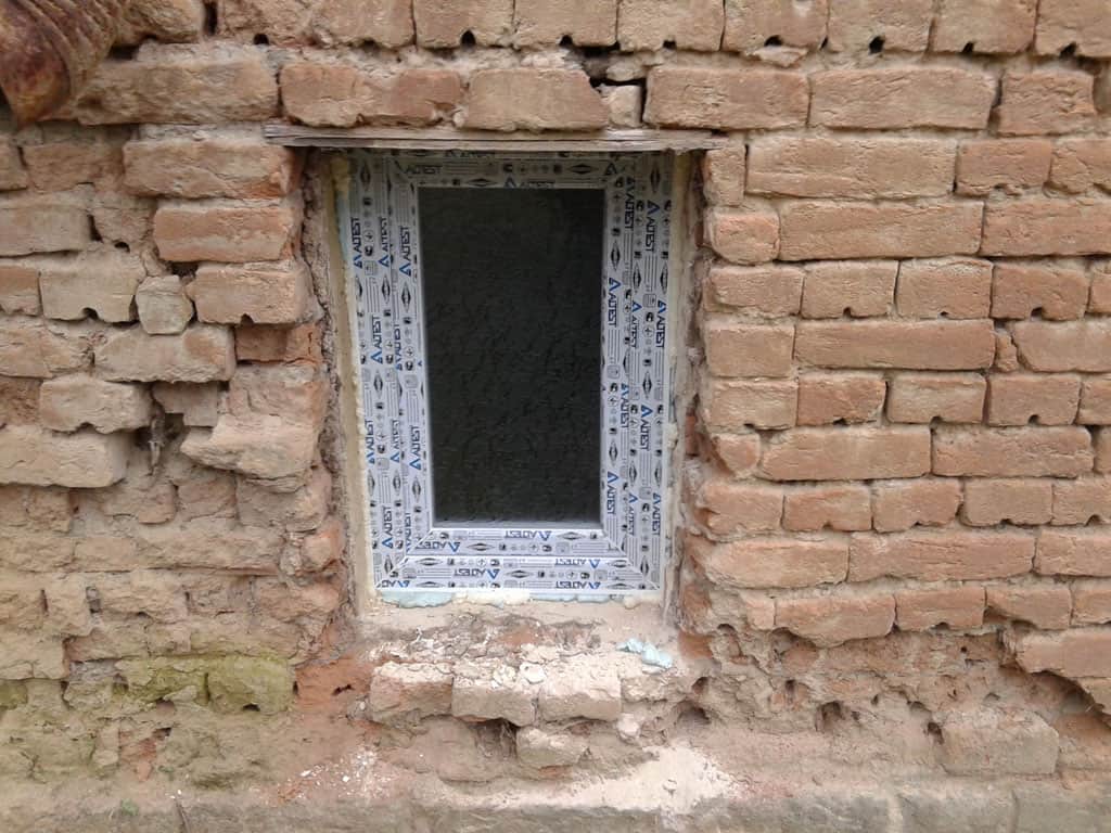 Brick wall with window opening for renovation project.