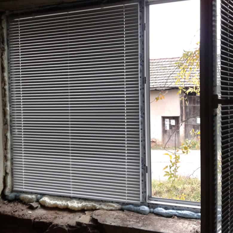 Interior view of a house window with blinds during renovation in Bulgaria.