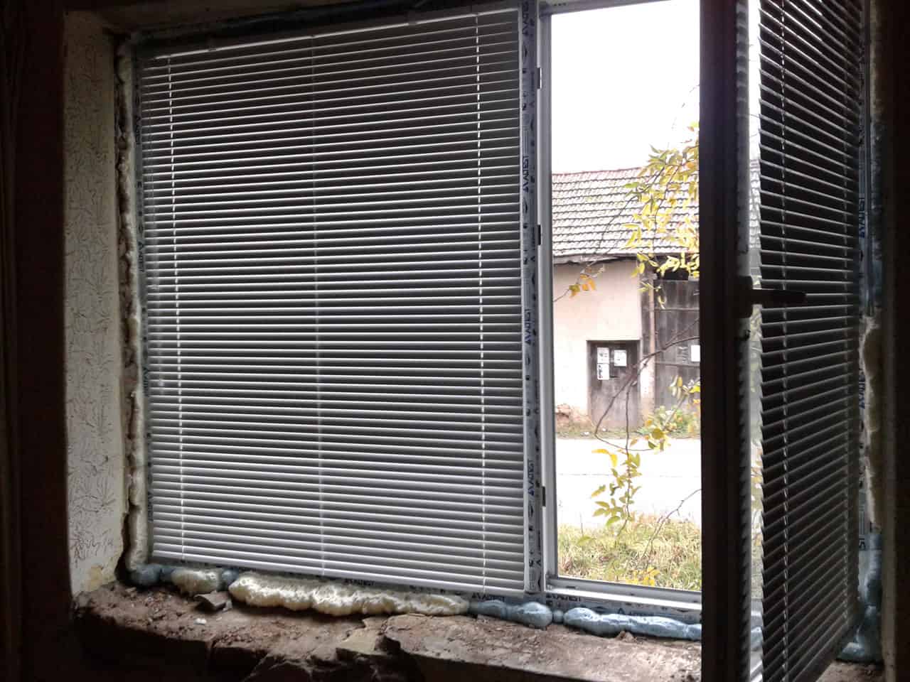 Interior view of a house window with blinds during renovation in Bulgaria.