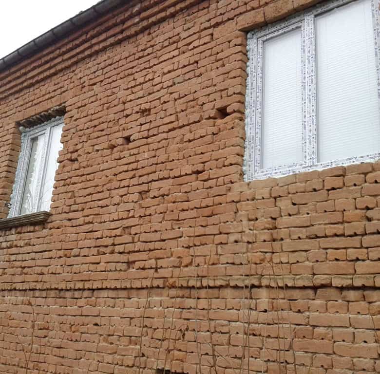 Exterior view of a brick house for renovation in Stezherovo, Bulgaria.
