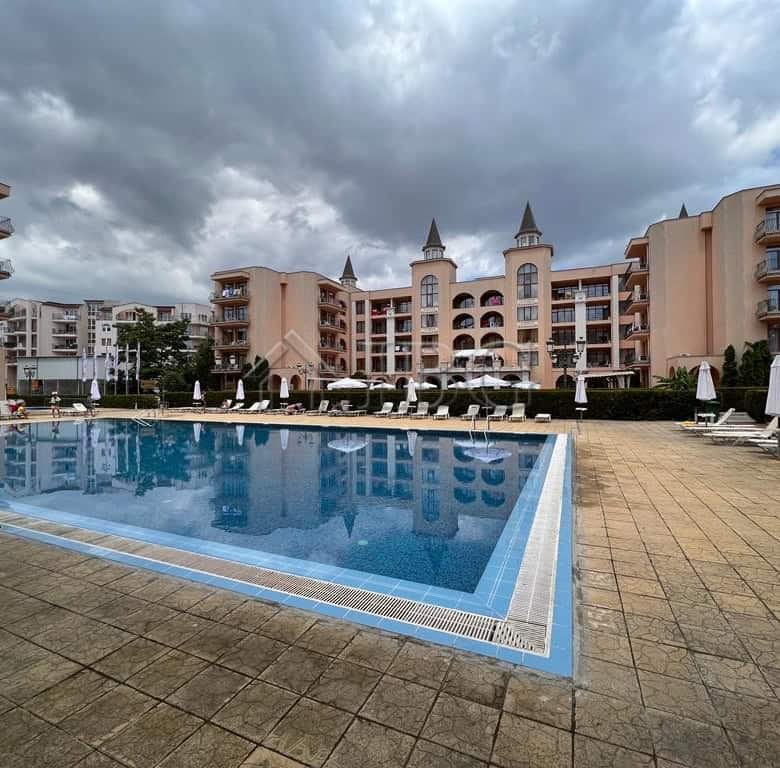 Pool view of a spacious studio apartment in Palazzo complex, Sunny Beach. Modern amenities and sceni.