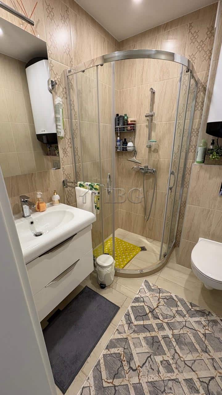 Comfortable 1-bedroom apartment with modern shower, located in Pomorie Residence, offering a relaxin.