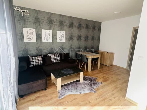 Bright living room with modern decor and natural sunlight in Sunny Beach apartment.