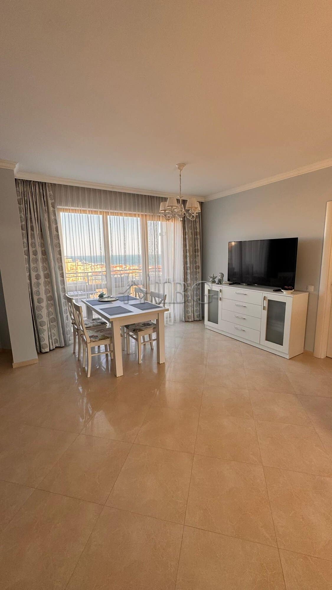 Bright living room with sea and mountain views in Sveti Vlas apartment.