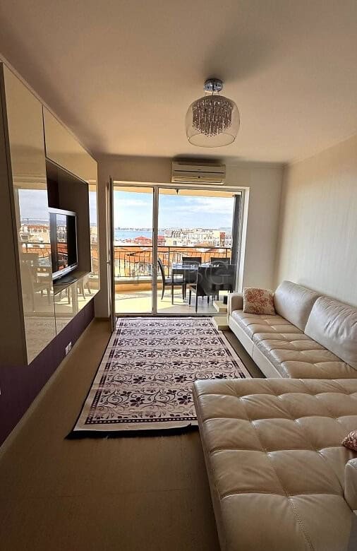 Modern living room with sea view, balcony, and pool access in Sveti Vlas.