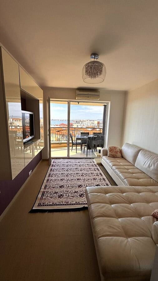 Modern living room with sea view, balcony, and pool access in Sveti Vlas.
