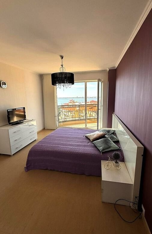 Bright bedroom with sea and pool views in Sveti Vlas apartment.
