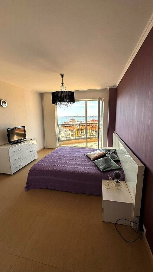 Bright bedroom with sea and pool views in Sveti Vlas apartment.
