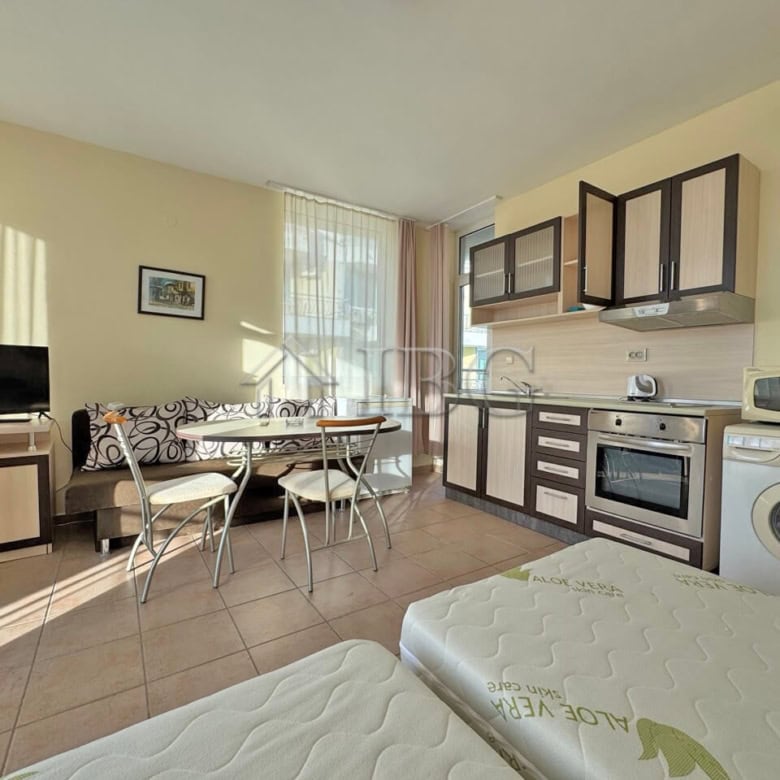 Modern 1-bedroom apartment with living area, kitchen, and amenities in Sunny Beach.
