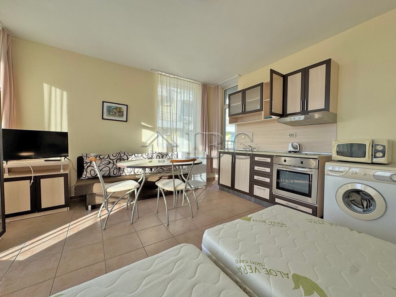 Modern 1-bedroom apartment with living area, kitchen, and amenities in Sunny Beach.