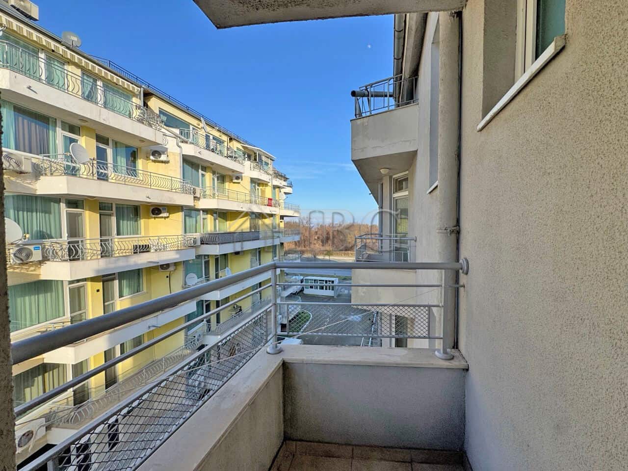 Balcony of a 1-bedroom apartment at Apart Hotel Favorit, Sunny Beach, showcasing modern building fac.
