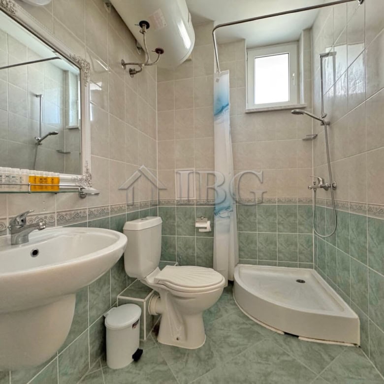 Bright bathroom with modern fixtures and shower area in Sunny Beach apartment.