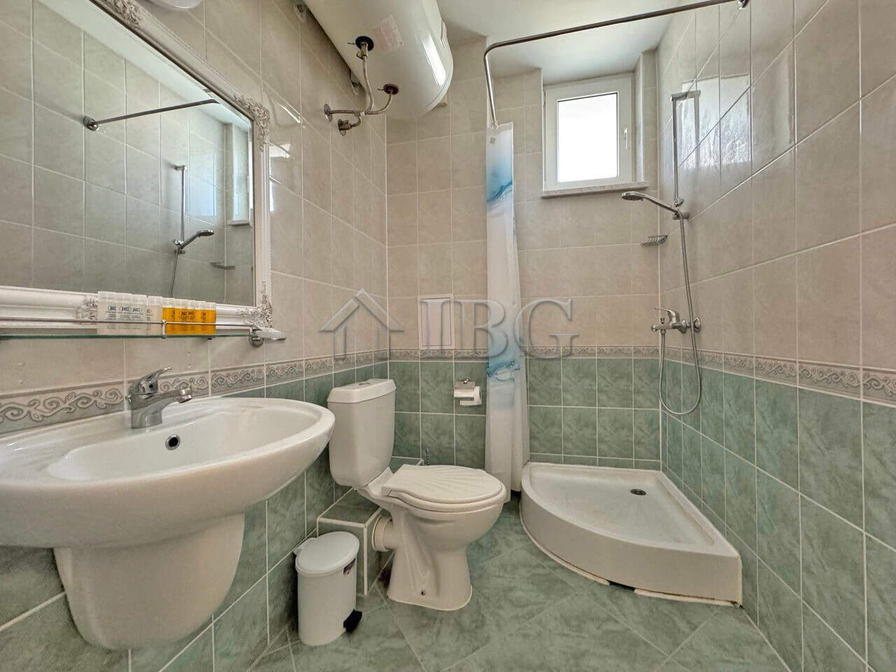 Bright bathroom with modern fixtures and shower area in Sunny Beach apartment.
