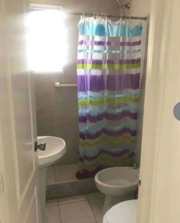 Bathroom with shower, toilet, and sink in La Pastora, Punta del Este.