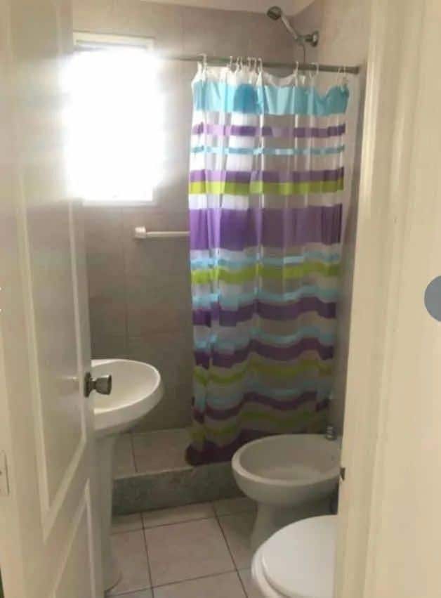 Bathroom with shower, toilet, and sink in La Pastora, Punta del Este.