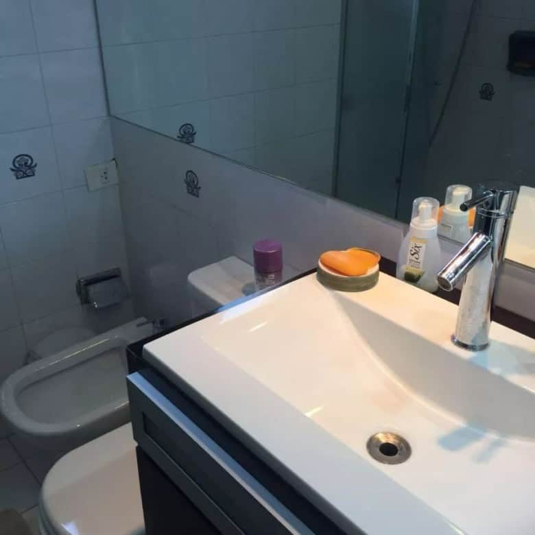 Bathroom with sink, mirror, and toiletries in a modern apartment in Maldonado.