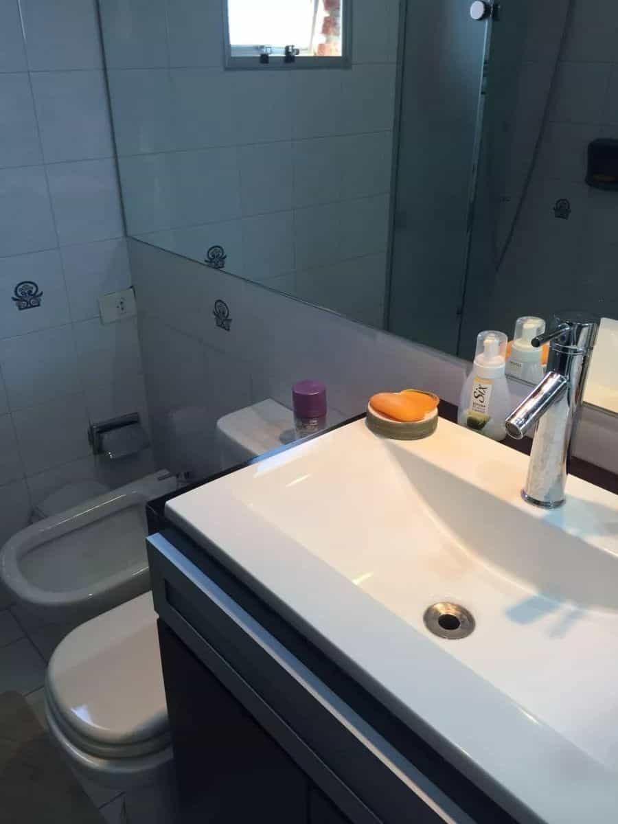 Bathroom with sink, mirror, and toiletries in a modern apartment in Maldonado.