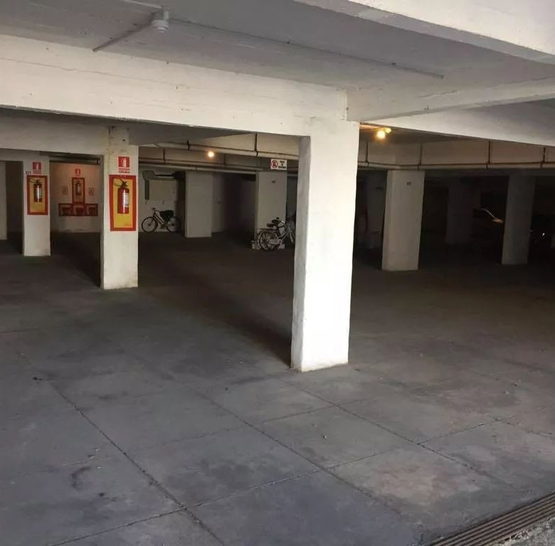Secure underground parking area with designated spots and safety features.