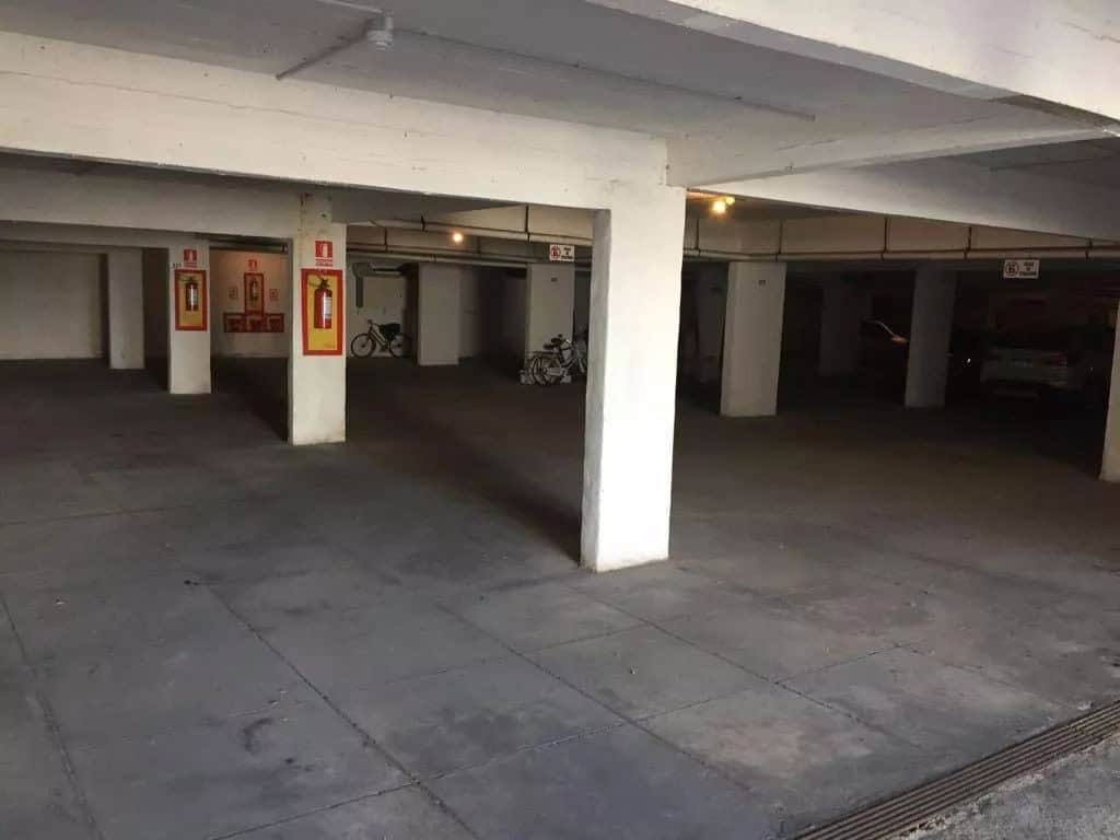 Secure underground parking area with designated spots and safety features.