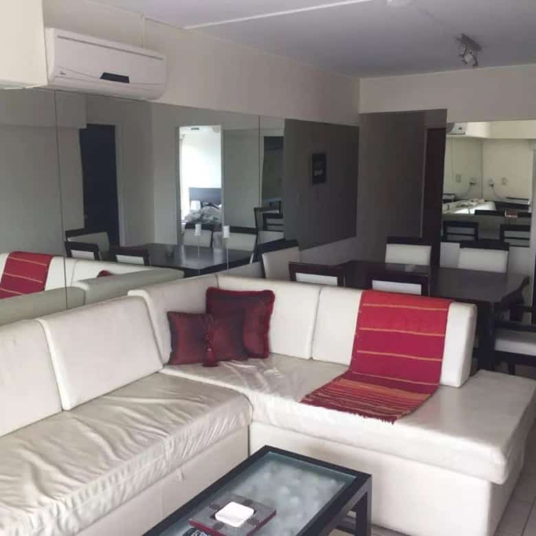 Spacious interior with white sofa, red cushions, and contemporary decor.