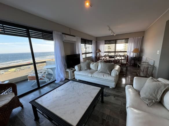 Spacious living room with large windows overlooking the ocean in Punta del Este, Maldonado. Modern f.