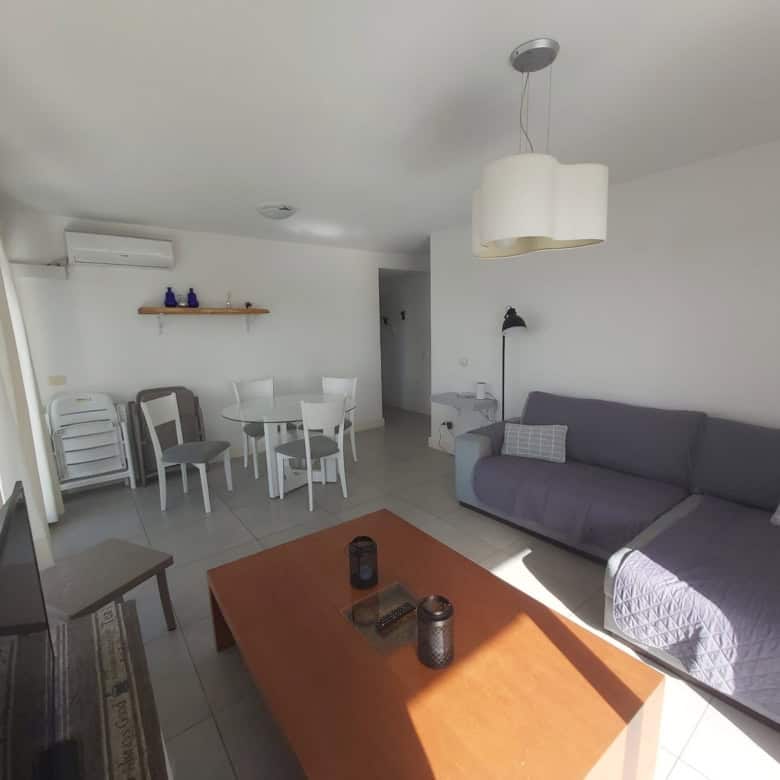 Bright living room with sofa, dining area, and natural light in La Pastora, Punta del Este.