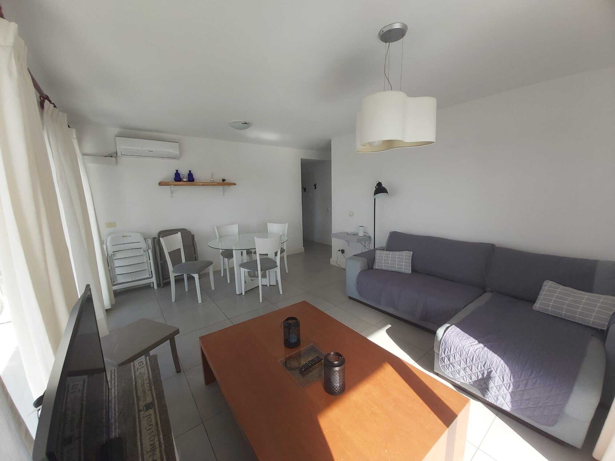 Bright living room with sofa, dining area, and natural light in La Pastora, Punta del Este.