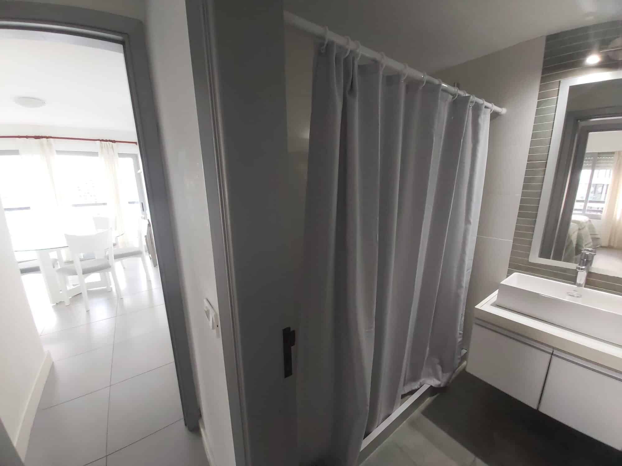 Apartment bathroom with shower and vanity in Punta del Este, Maldonado, Uruguay.