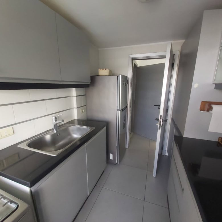 Apartment kitchen with stainless steel sink and modern appliances in La Pastora, Punta del Este.