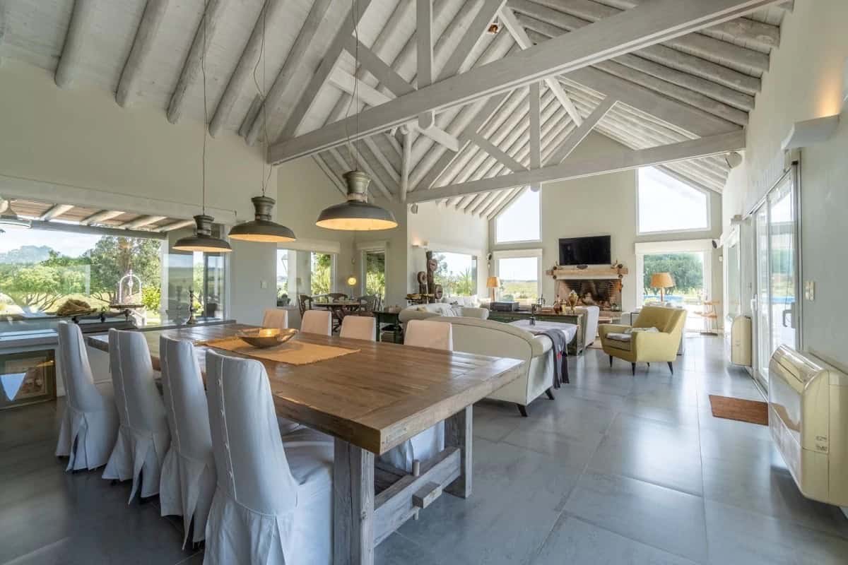Spacious open-plan living and dining area with high vaulted ceilings and large windows in Punta Ball.