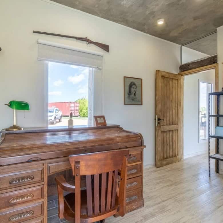 Cozy interior of a country house in Punta Ballena, Maldonado, featuring wooden furniture, a large wi.