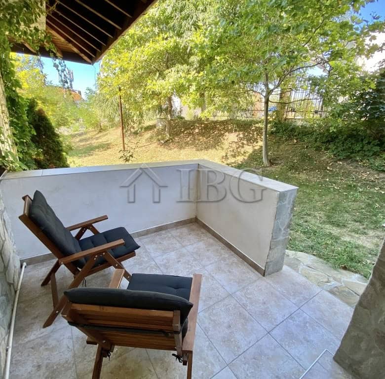 Balcony with seating overlooking greenery in Sveti Vlas, Bulgaria.