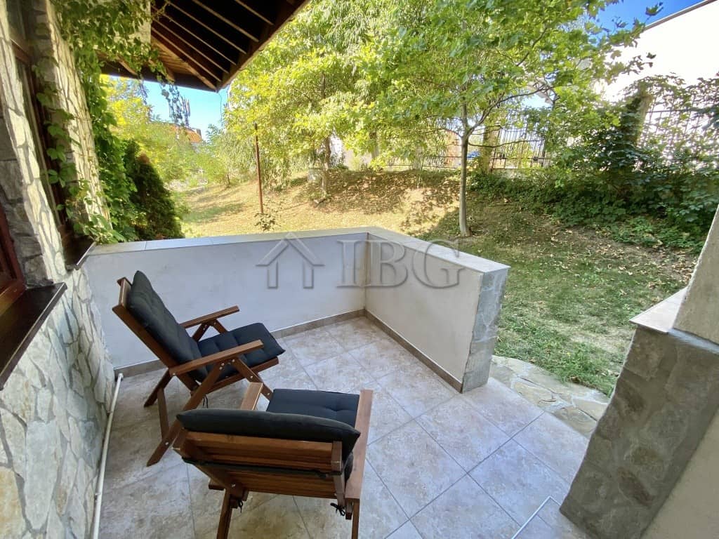 Balcony with seating overlooking greenery in Sveti Vlas, Bulgaria.