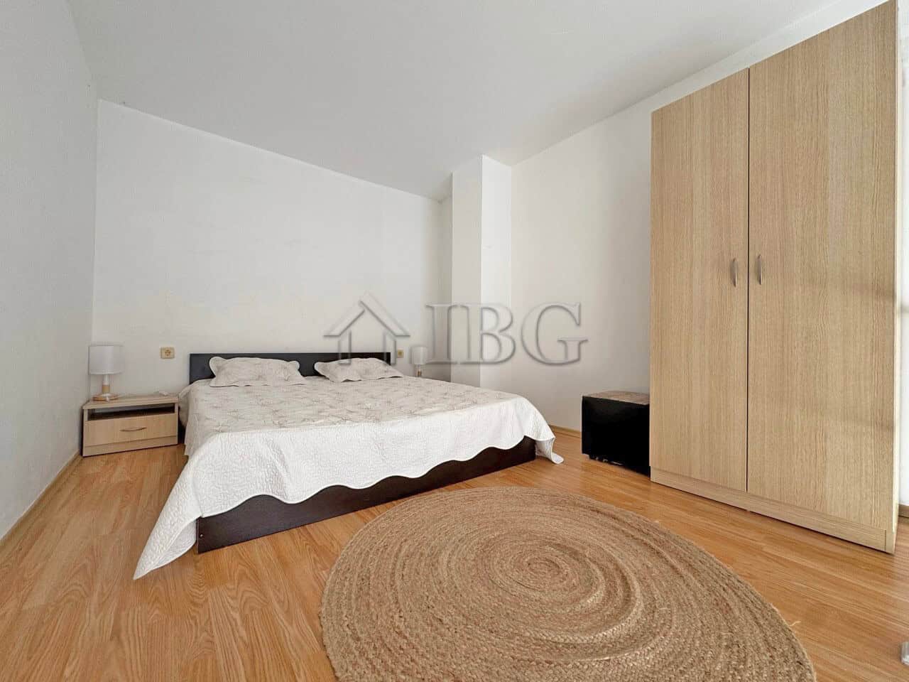 Bright bedroom with double bed and wooden furniture in Gerber Residence 3, Sunny Beach.